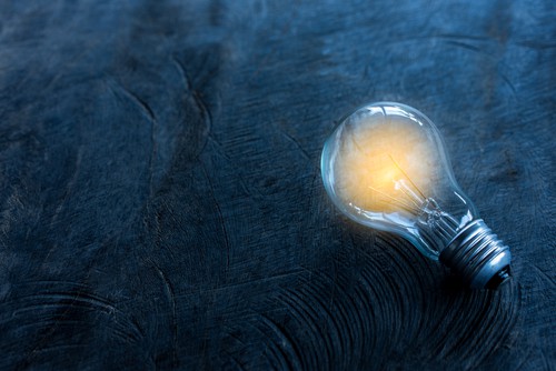 Lightbulb innovation against dark background
