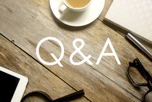 Q&A on wooden table with tea, ipad and glasses